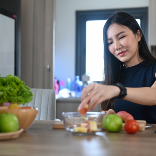 Happy Young Woman Storing Salad Organic Fruits and Veg at home